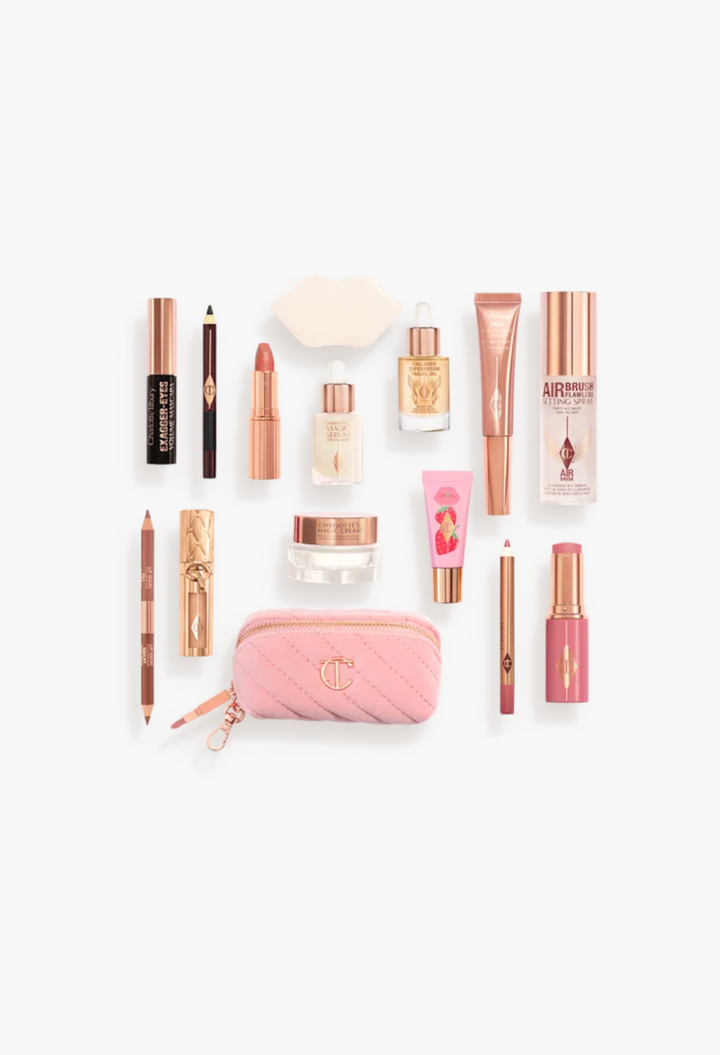 GLAM MODA Charlotte Tilbury beauty advent calendar contents including makeup, skincare, and a pink quilted makeup bag.