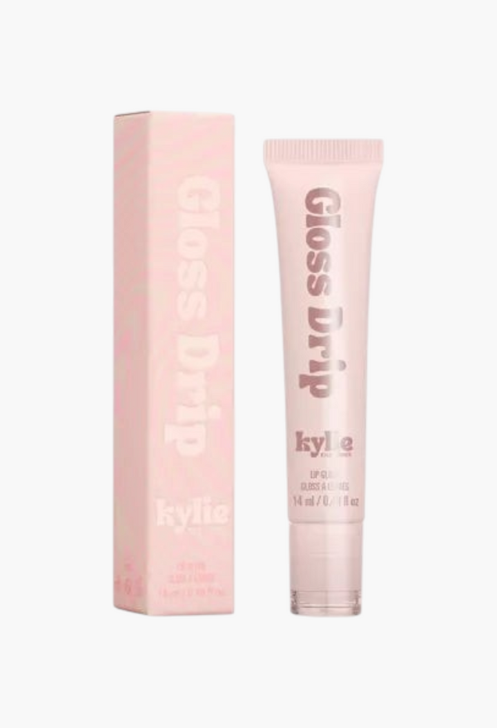 GLAM MODA Kylie by Kylie Jenner Gloss Drip lipgloss in a light pink squeeze tube with matching product packaging.