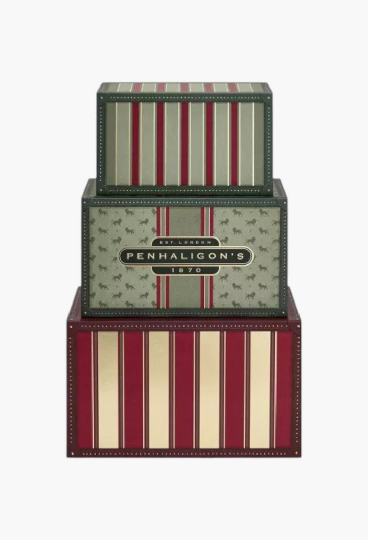 GLAM MODA Penhaligon's 2026 advent calendar featuring stacked vintage-style travel trunk boxes in red and green.