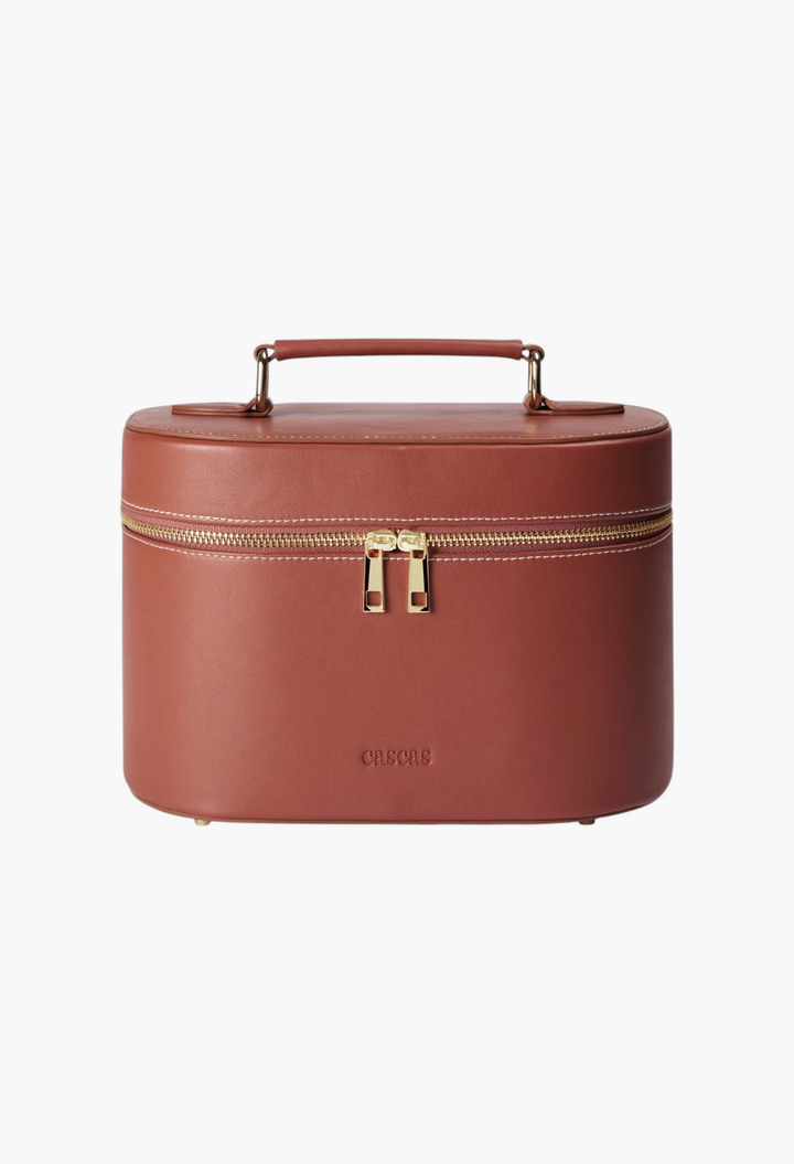 GLAM MODA oval espresso brown vegan leather vanity case with gold zipper hardware and a top handle.
