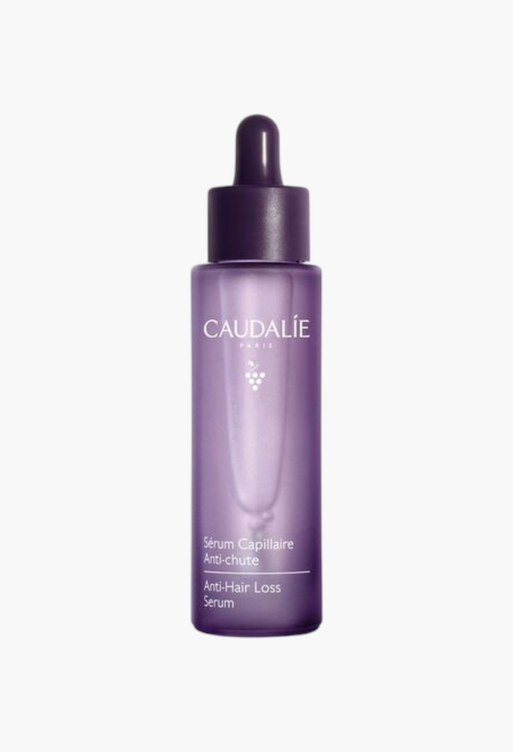 GLAM MODA Caudalie anti-hair loss serum in a purple glass bottle with a dropper for hair thickening and growth