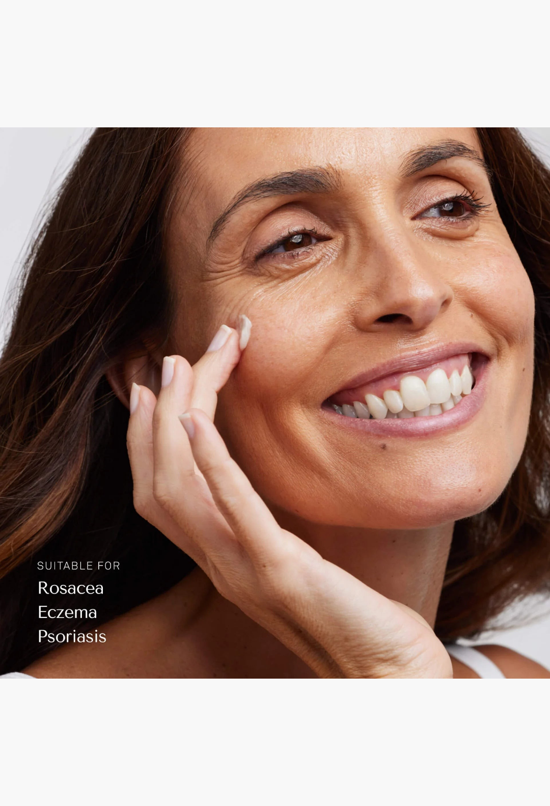 GLAM MODA Le Balm solid serum being applied to the cheek of a smiling woman with sensitive skin