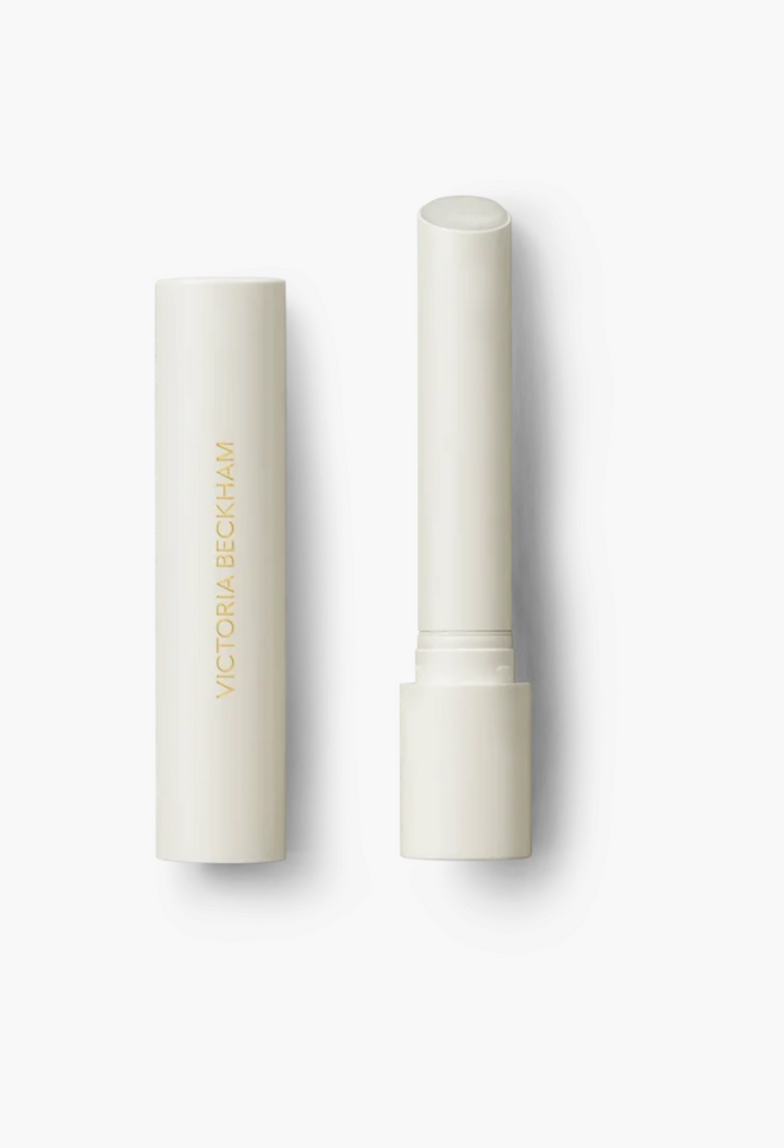 GLAM MODA Posh Balm Nourishing Lip Shine in a sleek, minimalist off-white twist-up tube with gold lettering.