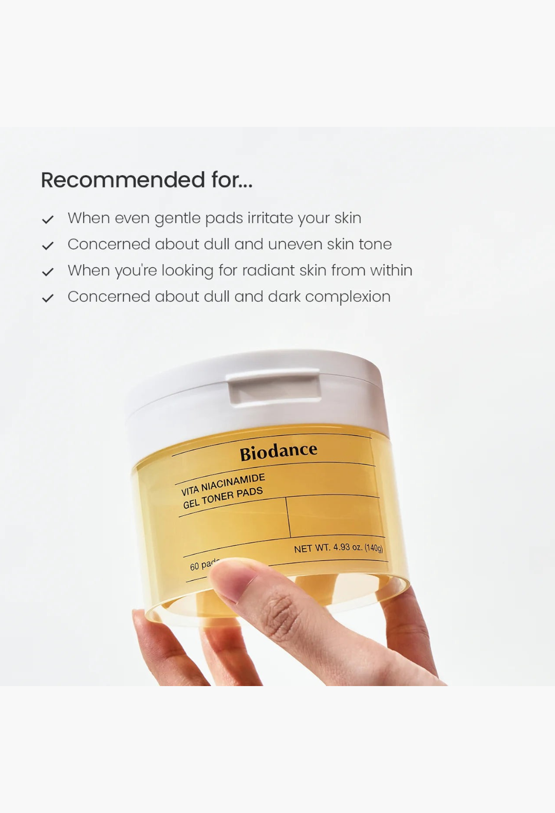 GLAM MODA Biodance Vita Niacinamide Gel Toner Pads in a yellow translucent jar held by a hand