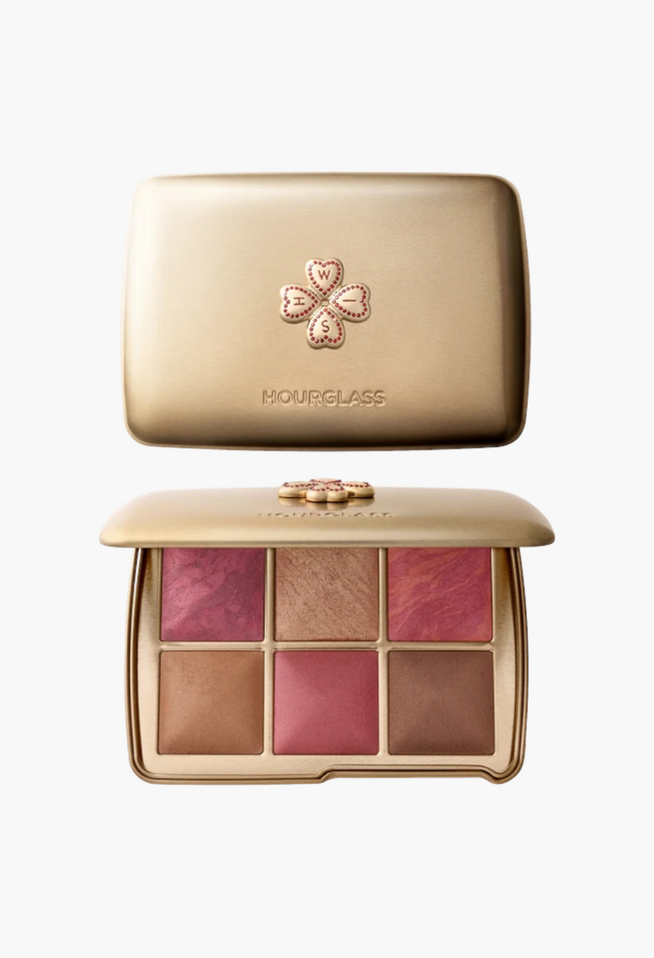 GLAM MODA Hourglass Ambient Lighting Edit Unlocked palette in a gold tin case with a decorative clover charm.