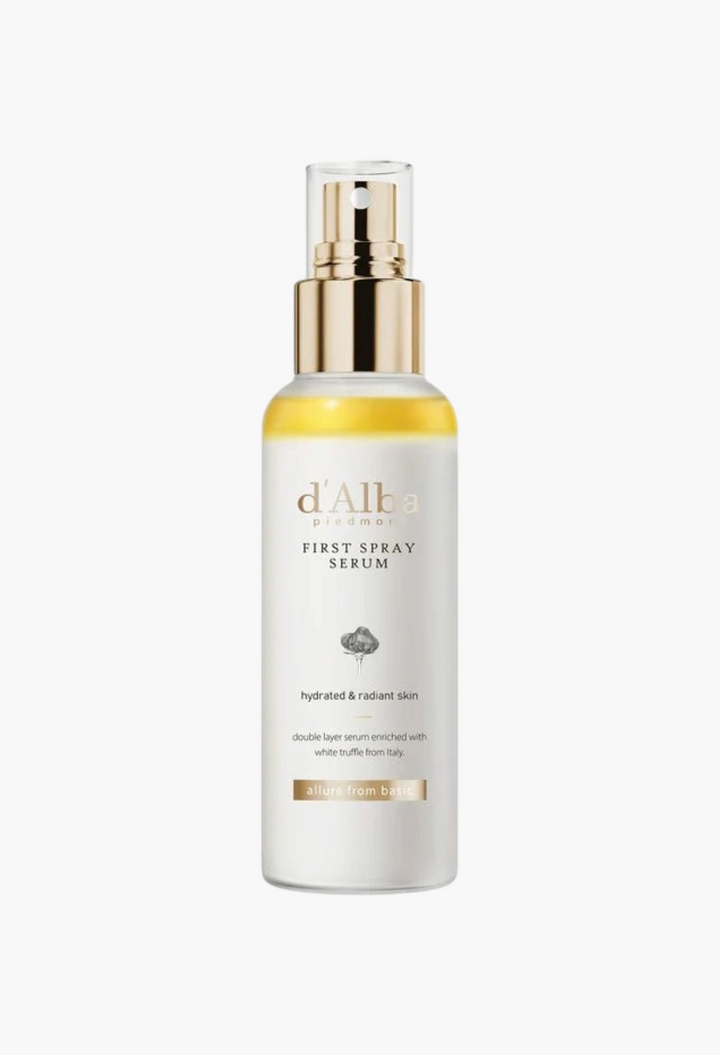 GLAM MODA d'Alba White Truffle First Spray Serum in a clear bottle with a gold pump, featuring a dual-layer formula.