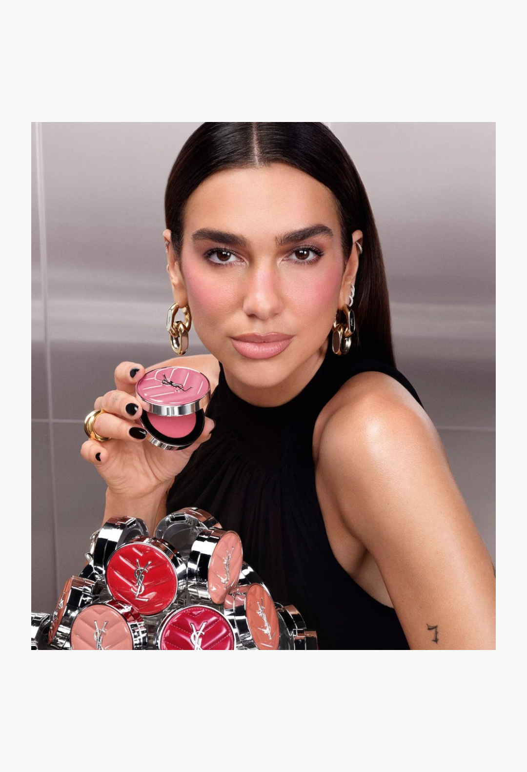 GLAM MODA model holding a pink YSL Make Me Blush cream blush compact with a dewy finish and vibrant pigment.