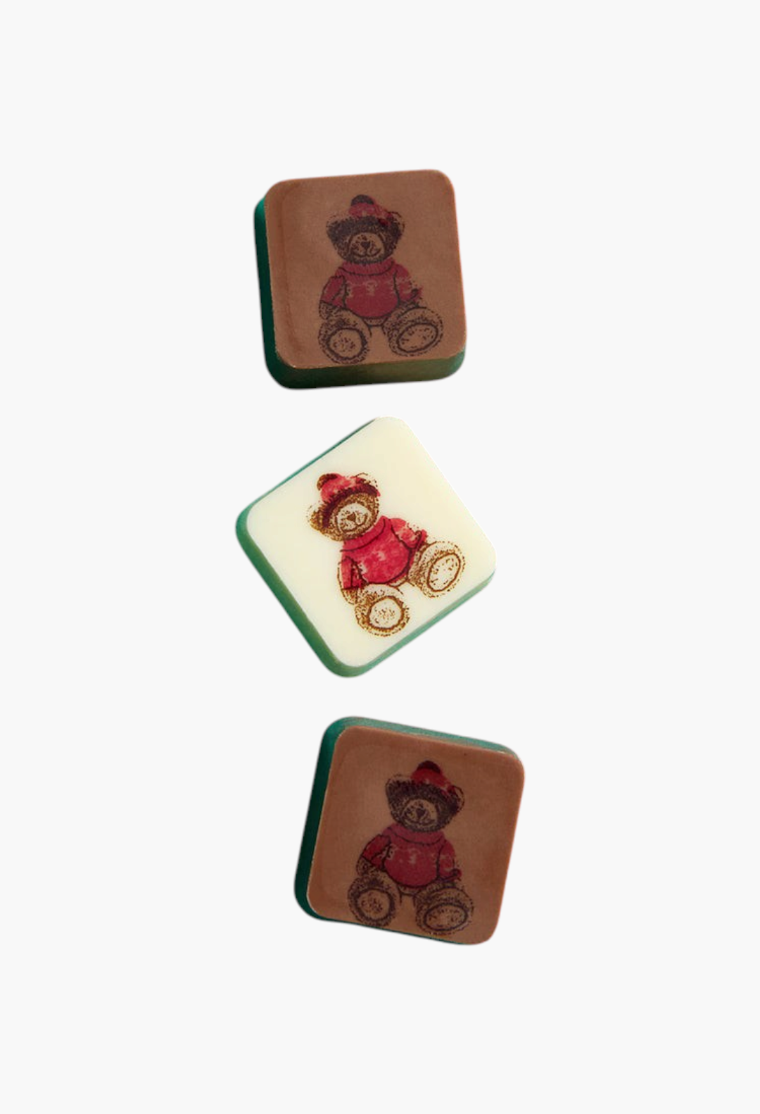GLAM MODA milk and white chocolate squares featuring a festive bear print on a vibrant teal background