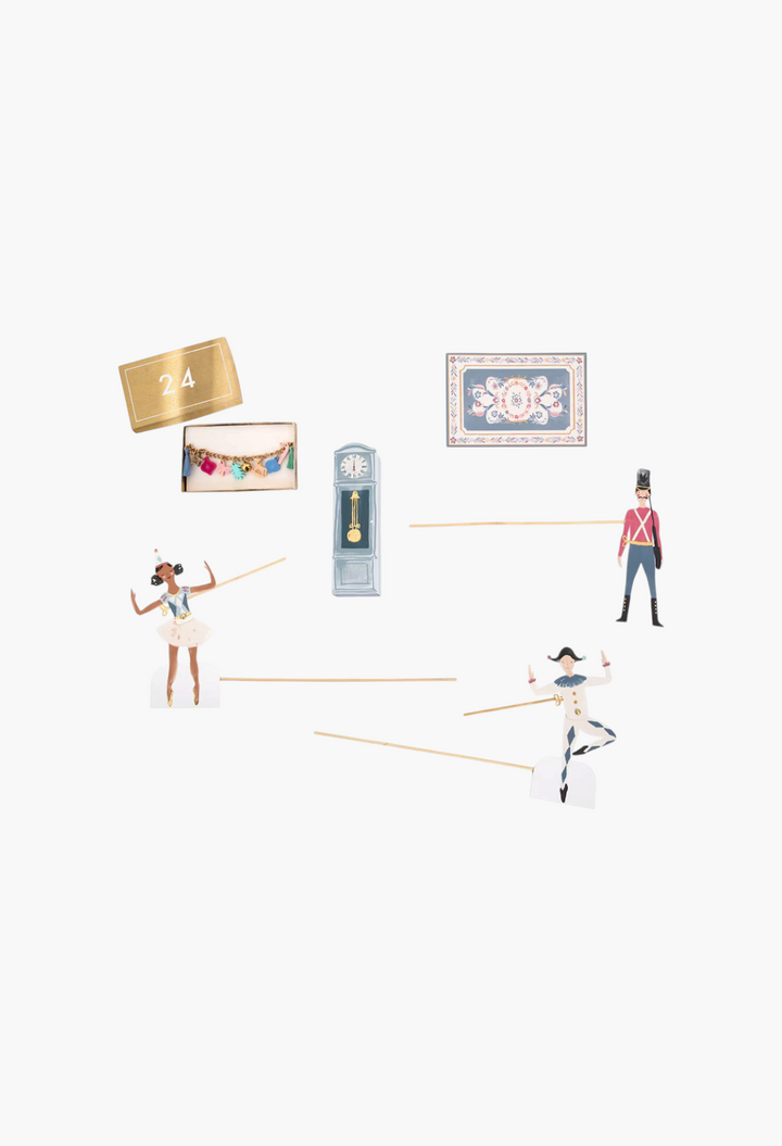 GLAM MODA Nutcracker advent calendar pieces including paper characters, a clock, a rug, and a gold-tone charm bracelet.