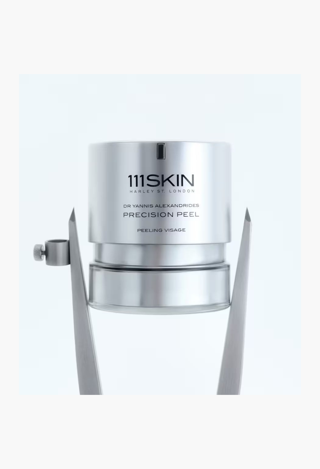 GLAM MODA 111SKIN Precision Peel resurfacing treatment in a sleek silver cylindrical bottle on a metallic stand.