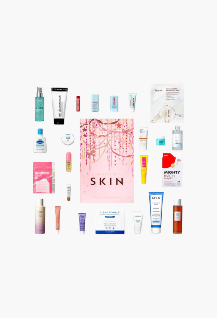 GLAM MODA 24 Days of Skin advent calendar surrounded by various full-size skincare products and beauty essentials.