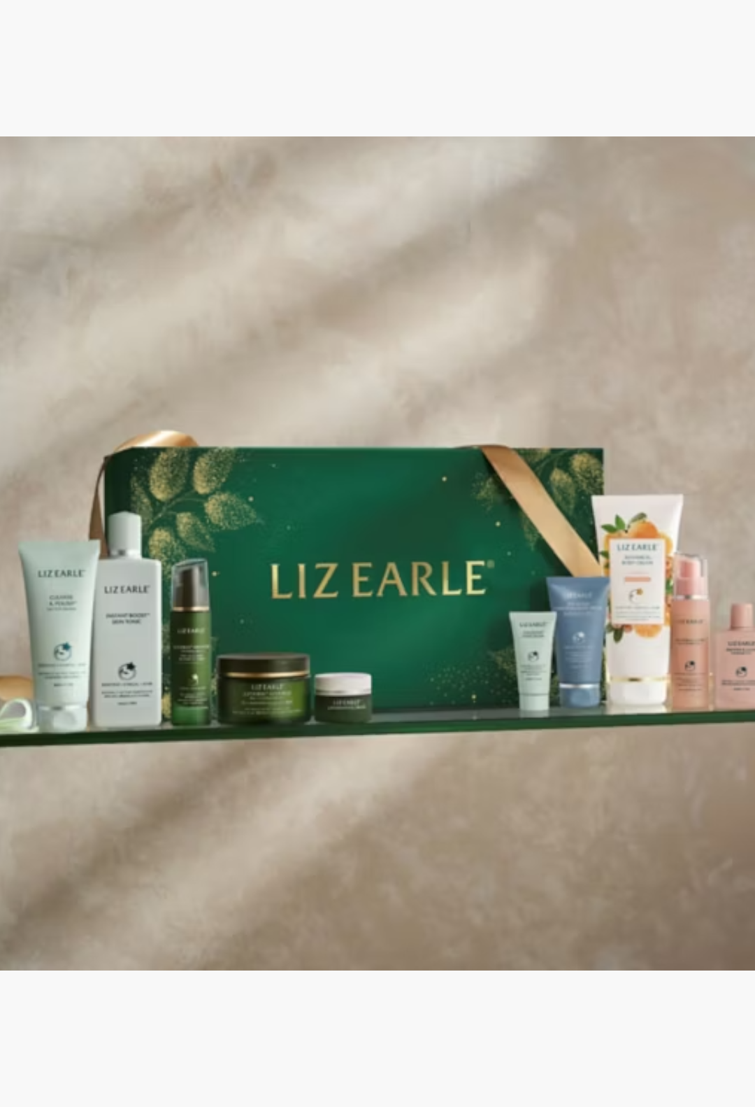 GLAM MODA Liz Earle 24 Days of Beauty Advent Calendar featuring various skincare products on a shelf.