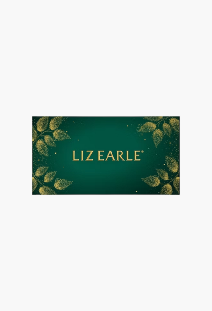 GLAM MODA Liz Earle 24 Days of Beauty Advent Calendar in a festive dark green box with gold leaf botanical accents.
