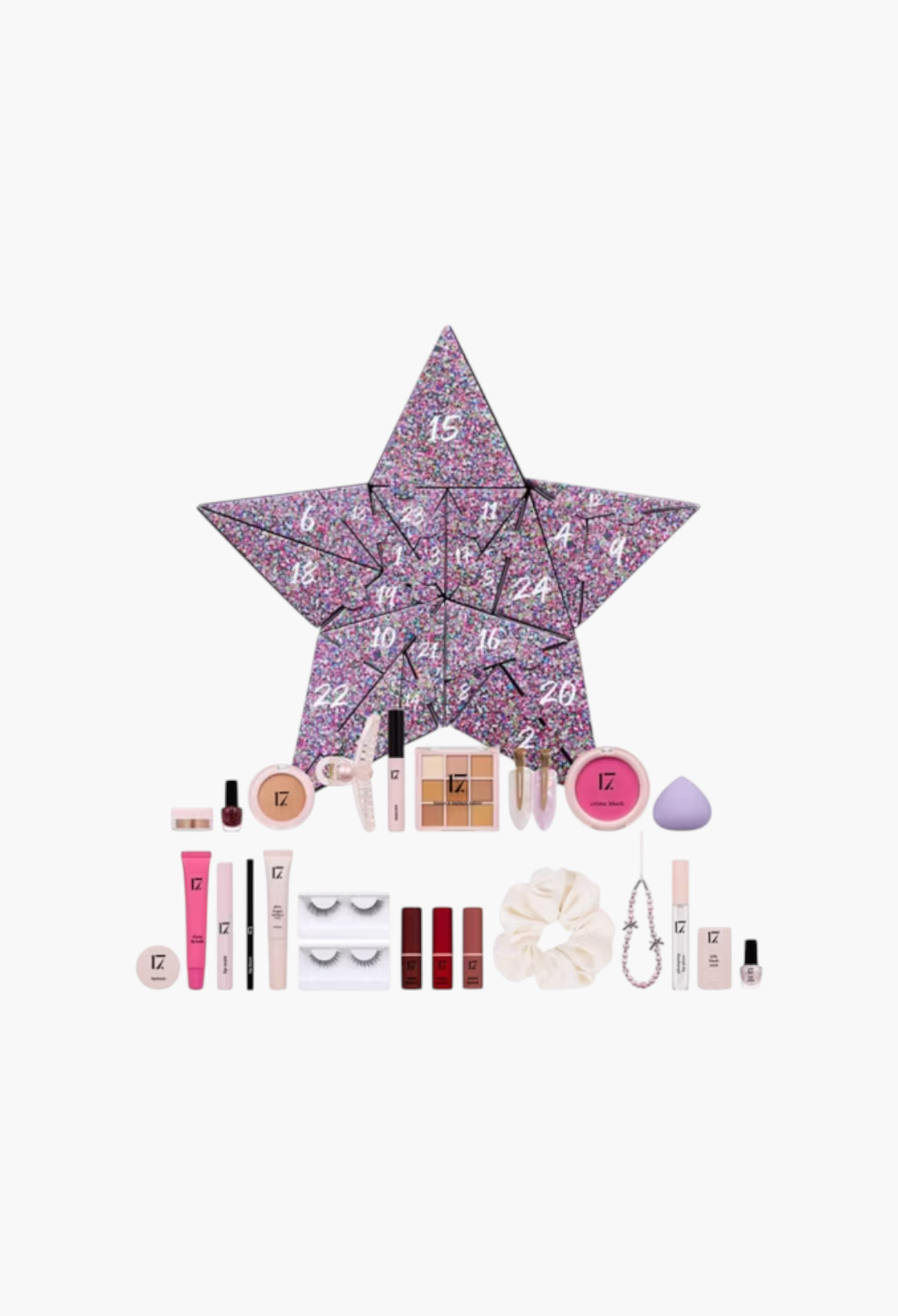 GLAM MODA 17 Xmas Icons star-shaped advent calendar with assorted makeup, nail polish, hair accessories, and beauty tools.