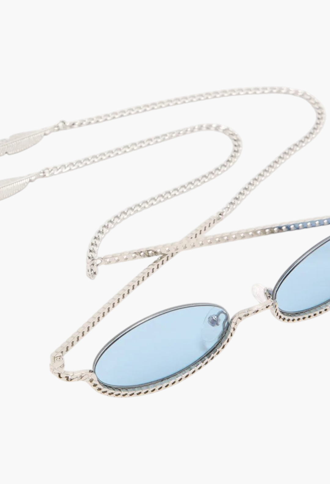 GLAM MODA Gaga sunglasses featuring oval blue lenses with a sculptural gold metal frame and integrated chain detail.