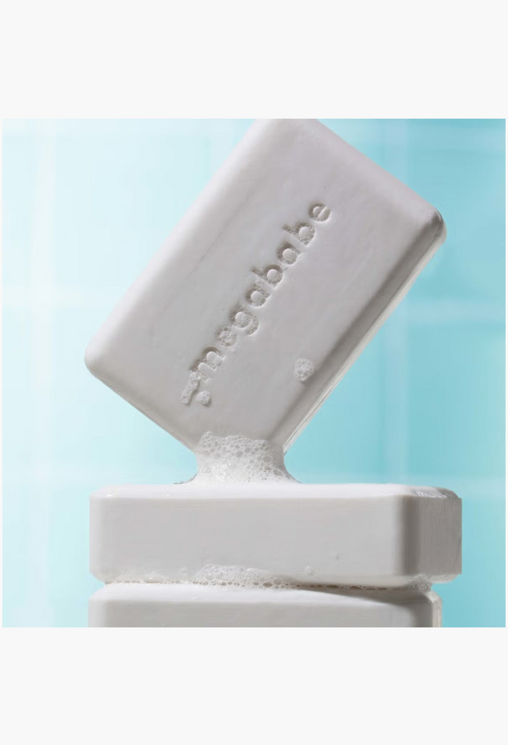 GLAM MODA Megababe Bidet Bar, a white pH-balancing feminine cleansing soap bar with a smooth, embossed surface.