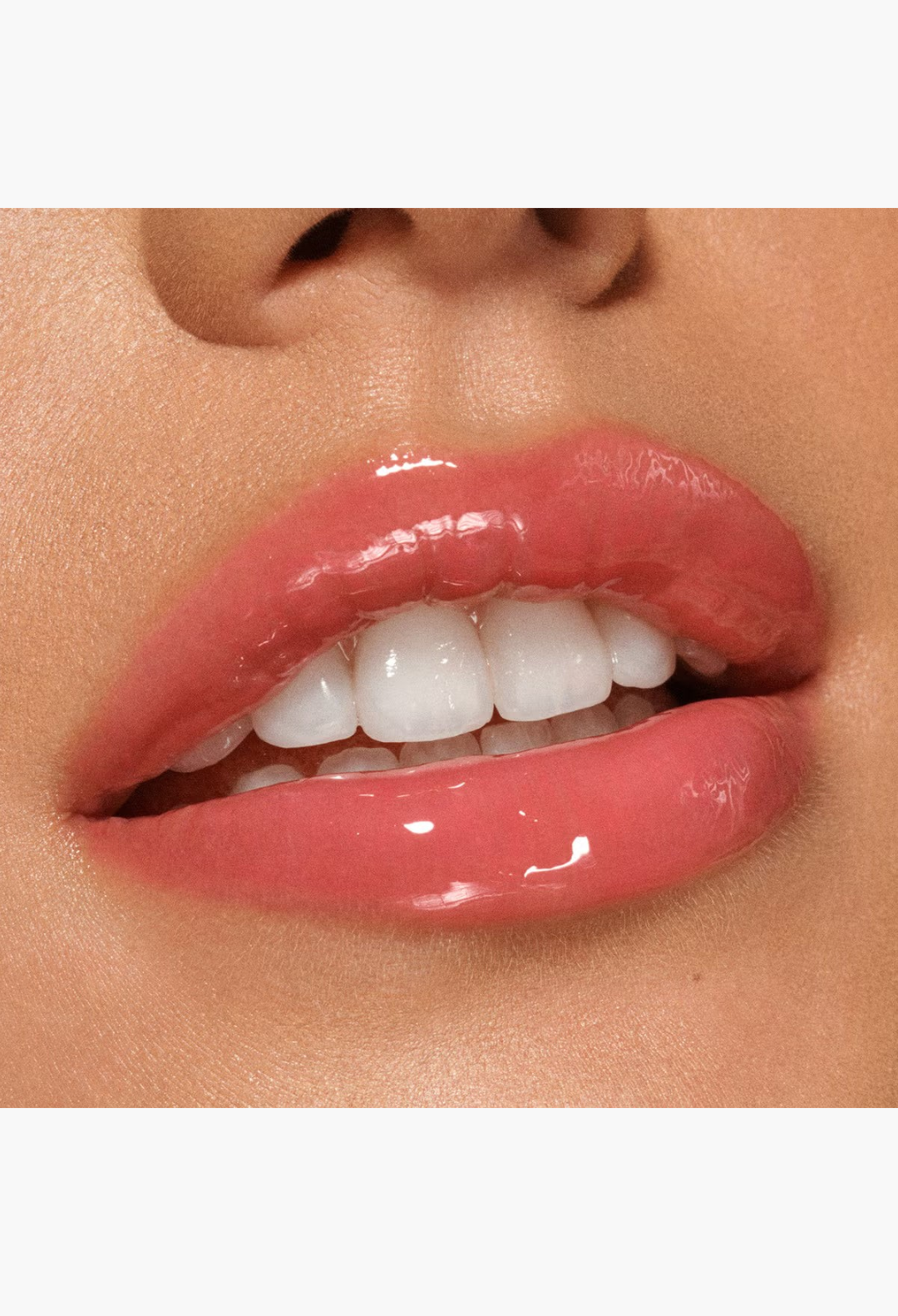 GLAM MODA VIEVE Lip Dew applied on lips for a high-shine, non-sticky, glossy finish with a soft pink tint.