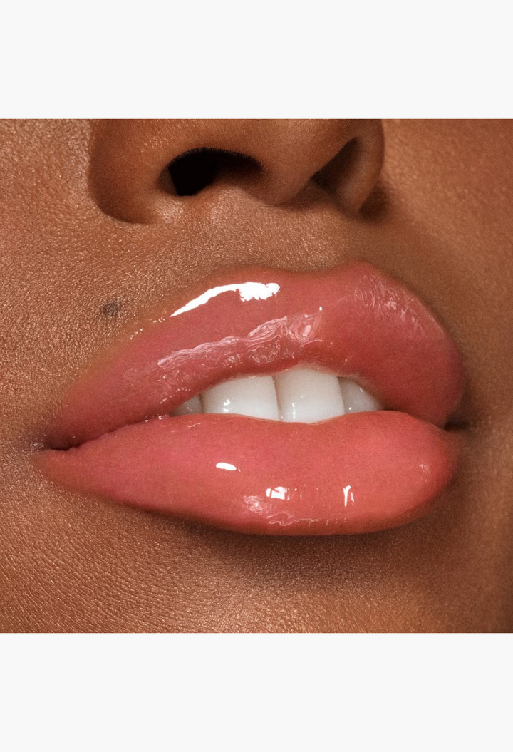 GLAM MODA VIEVE Lip Dew applied on lips for a high-shine, non-sticky, glossy finish with a natural pink tint.