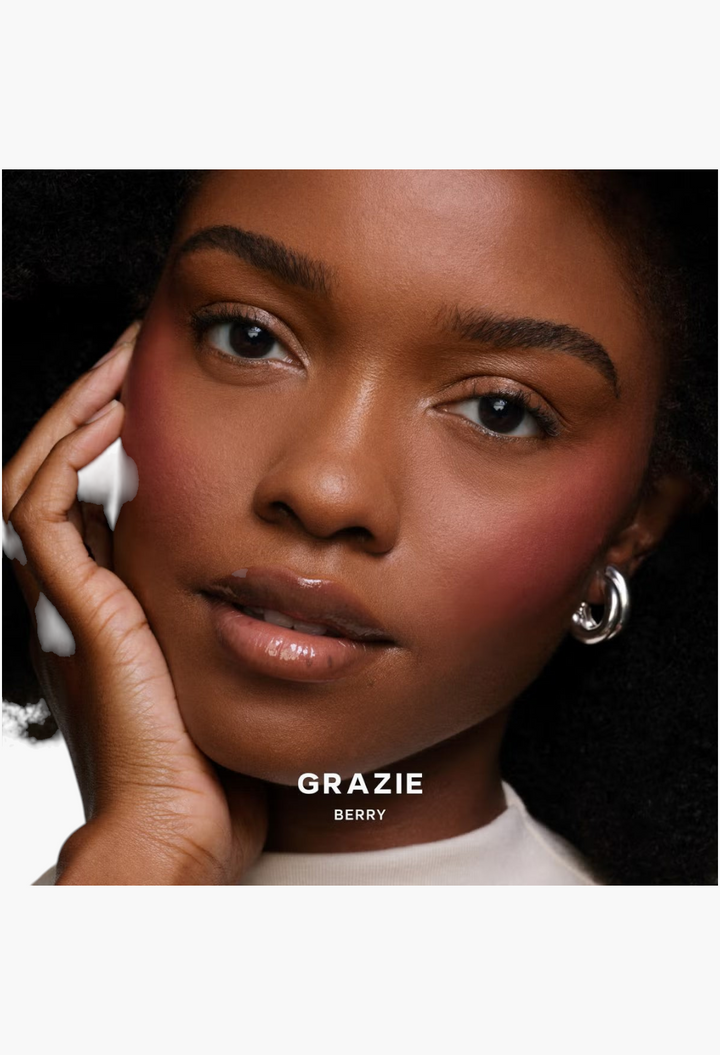 Model wearing GLAM MODA Saie SuperSuede Radiant Blush in Grazie Berry shade for a natural, glowing cheek flush.