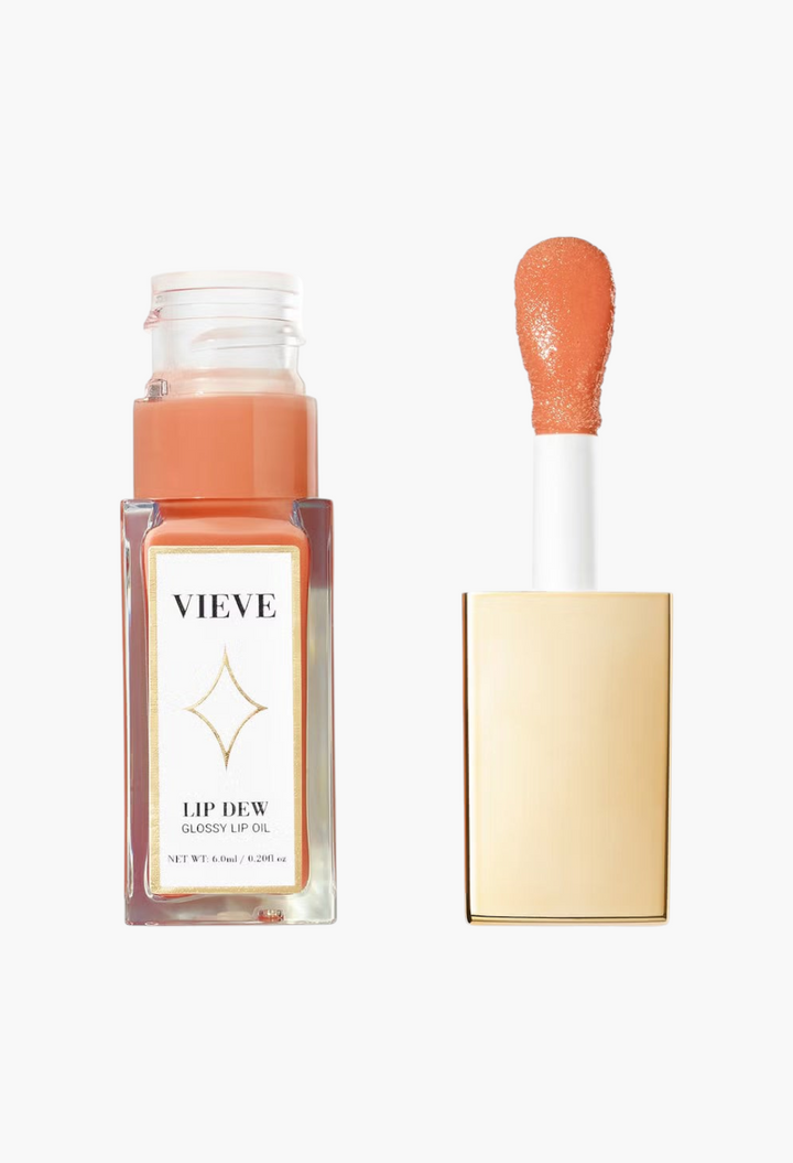 GLAM MODA VIEVE Lip Dew glossy lip oil in a clear bottle with a gold applicator wand and peach-toned formula