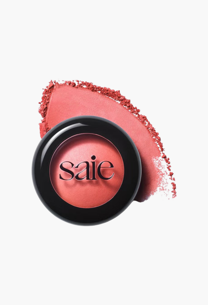 GLAM MODA Saie SuperSuede Radiant Blush in a round black compact with a soft coral powder swatch on a white background