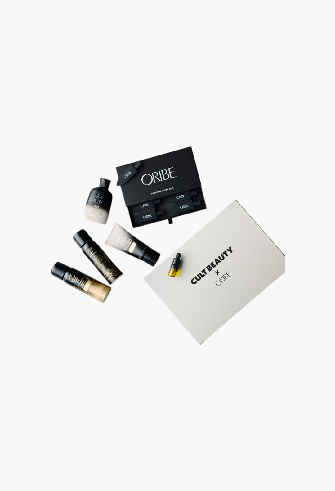 GLAM MODA Cult Beauty X Oribe haircare set featuring travel-sized shampoo, conditioner, sprays, oil, and hair clips.