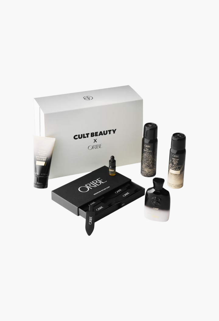 GLAM MODA Cult Beauty X Oribe haircare set featuring travel-sized shampoos, conditioners, sprays, oil, and hair clips.