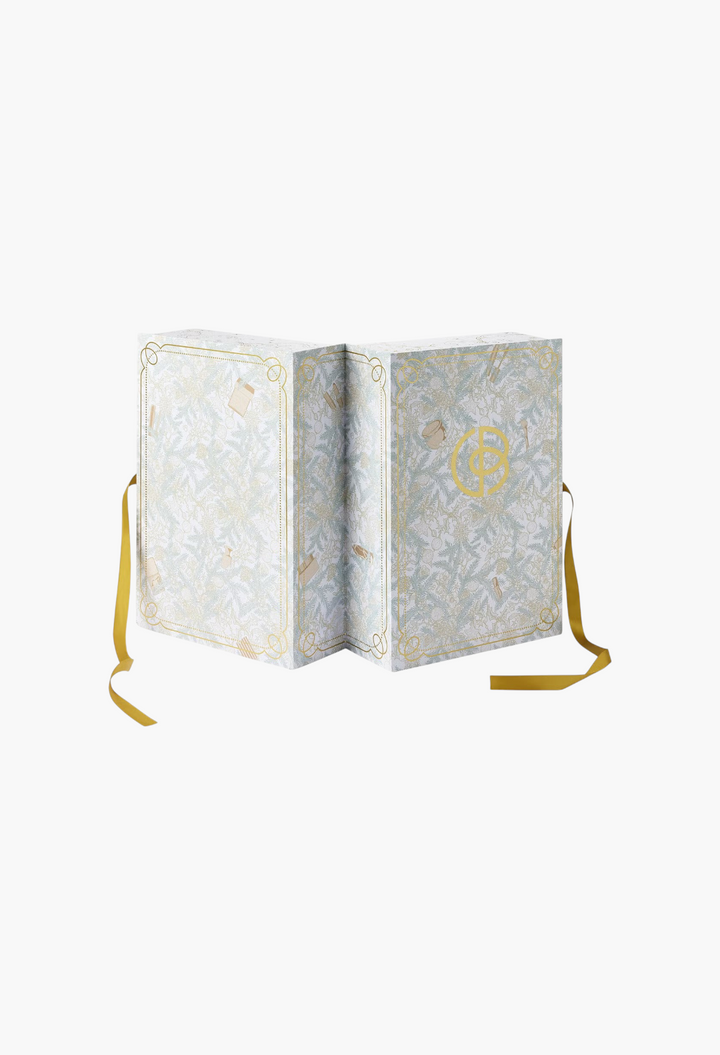 GLAM MODA Cult Beauty Advent Calendar Signature Edition with intricate botanical illustrations and gold ribbon ties.