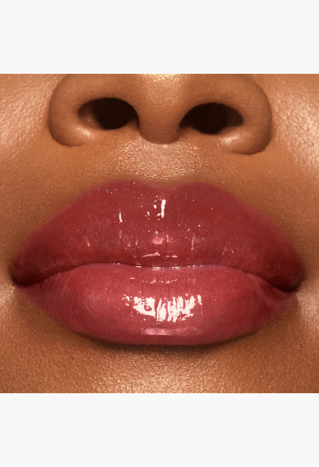GLAM MODA VIEVE Lip Dew applied on lips for a high-shine, non-sticky, glossy finish with a soft pink tint.