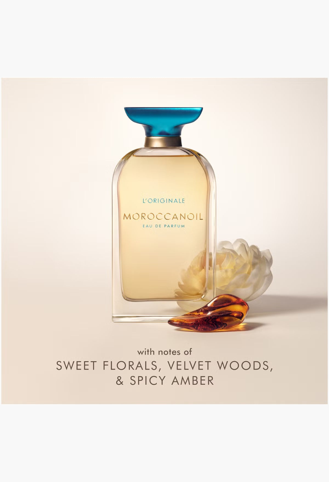 GLAM MODA Moroccanoil L'Originale Eau de Parfum bottle with a blue cap, featuring floral and amber accents.