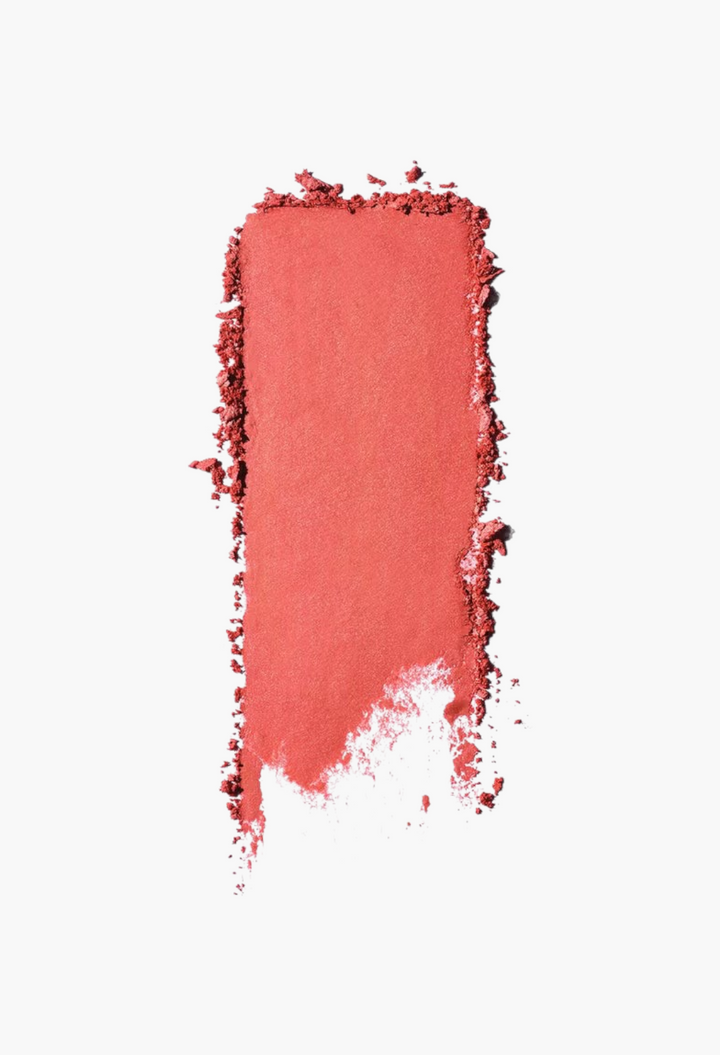 GLAM MODA Saie SuperSuede Radiant Blush powder swatch showing a smooth, vibrant coral-pink pigment texture