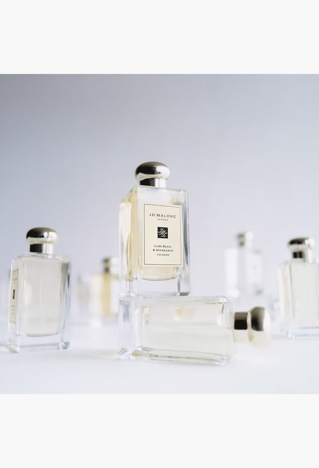 GLAM MODA Jo Malone London cologne bottles arranged on a white surface with a minimalist aesthetic