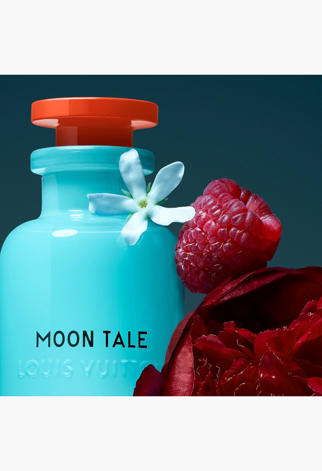 GLAM MODA Louis Vuitton Moon Tale perfume bottle in opalescent blue glass with orange cap, peony, and raspberry.