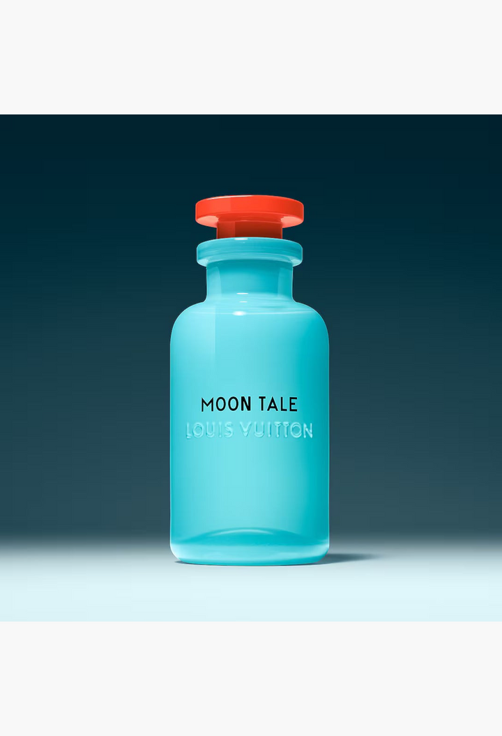 GLAM MODA Louis Vuitton Moon Tale perfume in an opalescent blue glass bottle with a vibrant red cap.