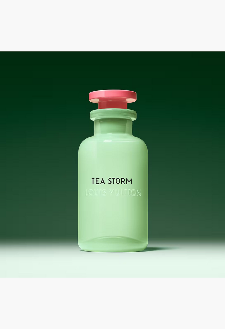 GLAM MODA Louis Vuitton Tea Storm perfume in an opalescent light green glass bottle with a pink cap.