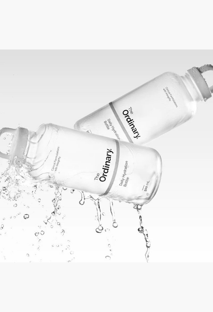GLAM MODA 500ml frosted glass Daily Hydration Bottle with a white screw cap, shown with splashing water.