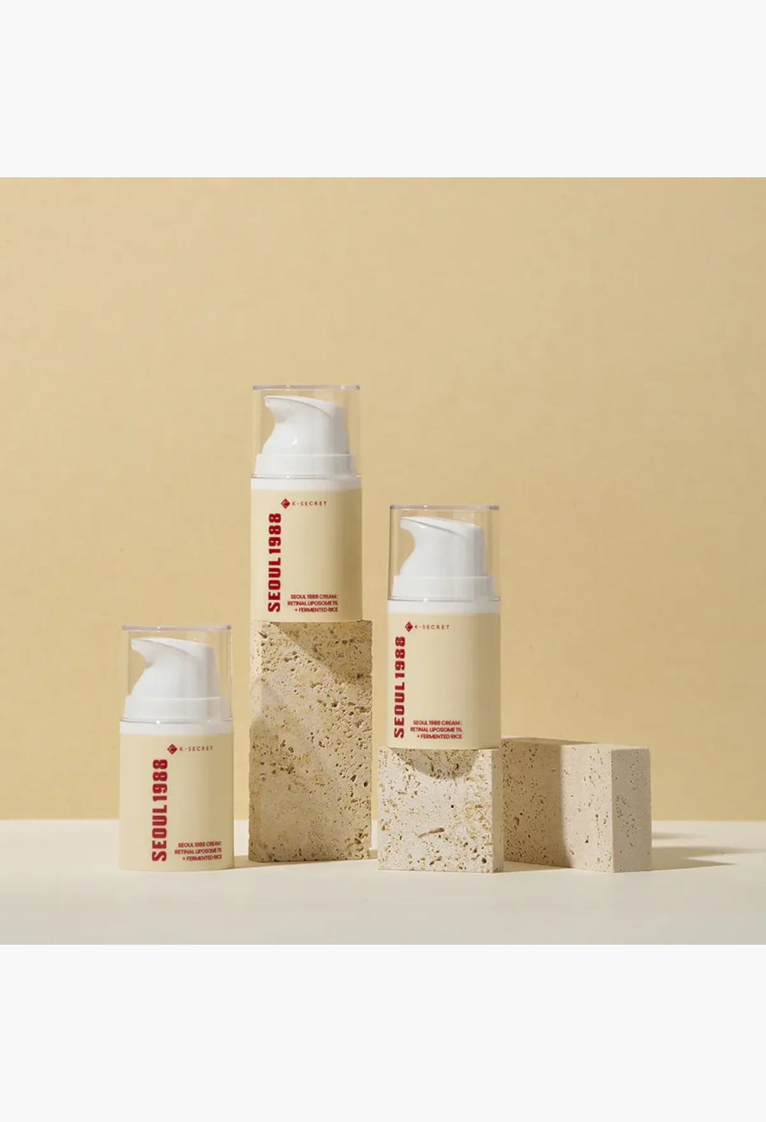GLAM MODA K Secret Seoul 1988 anti-aging cream bottles with retinol and rice ferment on stone pedestals
