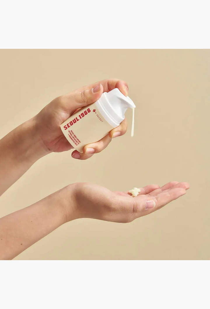 GLAM MODA K Secret Seoul 1988 anti-aging cream with retinol being dispensed from a pump bottle into a hand