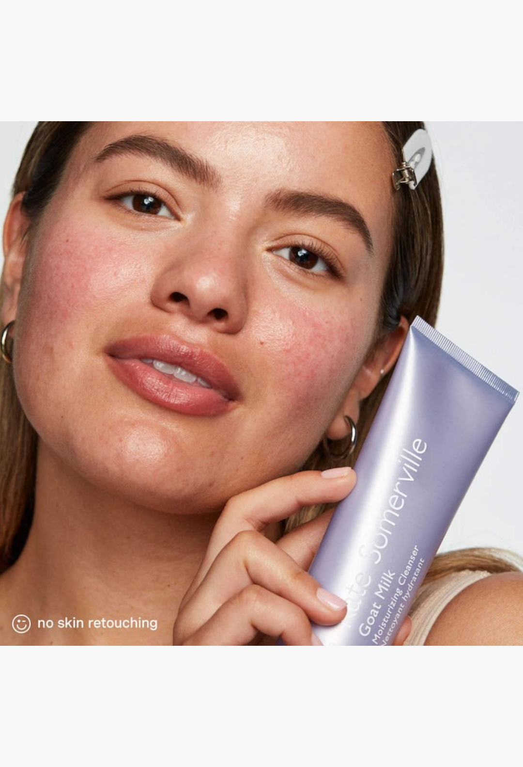 GLAM MODA Goat Milk Moisturizing Cleanser held by a woman with natural skin texture for dry and sensitive skin