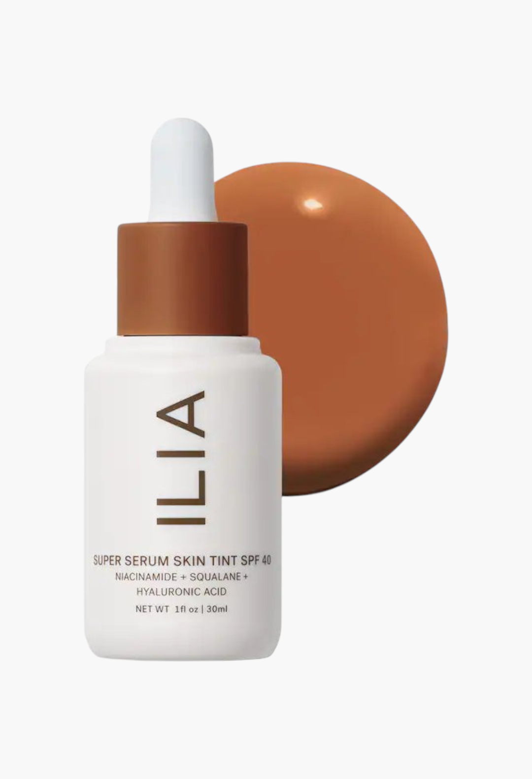 GLAM MODA ILIA Super Serum Skin Tint SPF 40 bottle with a brown liquid foundation swatch behind it.