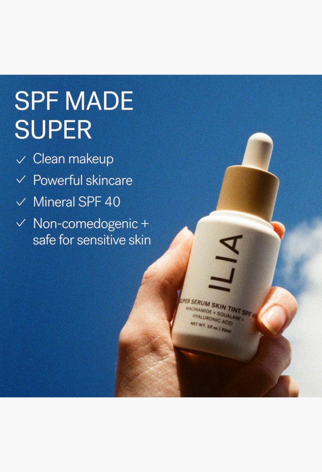 GLAM MODA ILIA Super Serum Skin Tint SPF 40 bottle held against a bright blue sky, highlighting clean skincare.