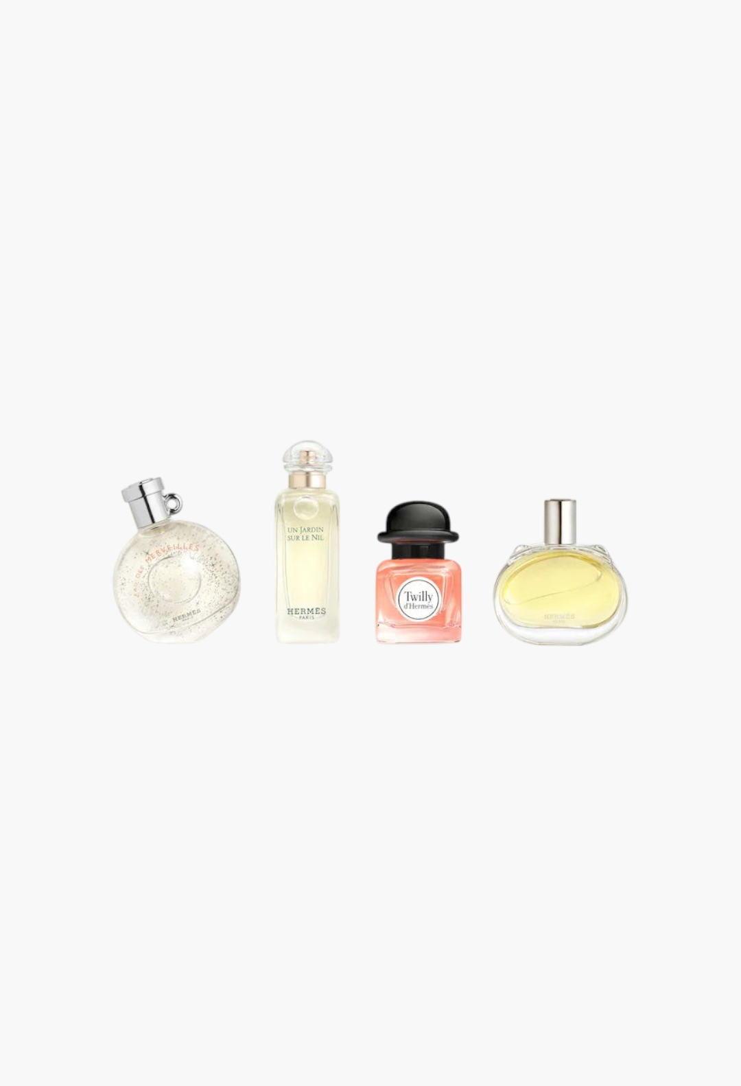 GLAM MODA Hermès fragrance discovery set featuring four mini perfume bottles with distinct glass shapes and scents.