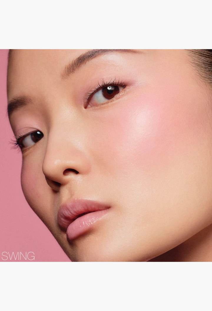 GLAM MODA soft blur blush stick applied to a model's cheeks and eyes for a natural pink monochromatic makeup look