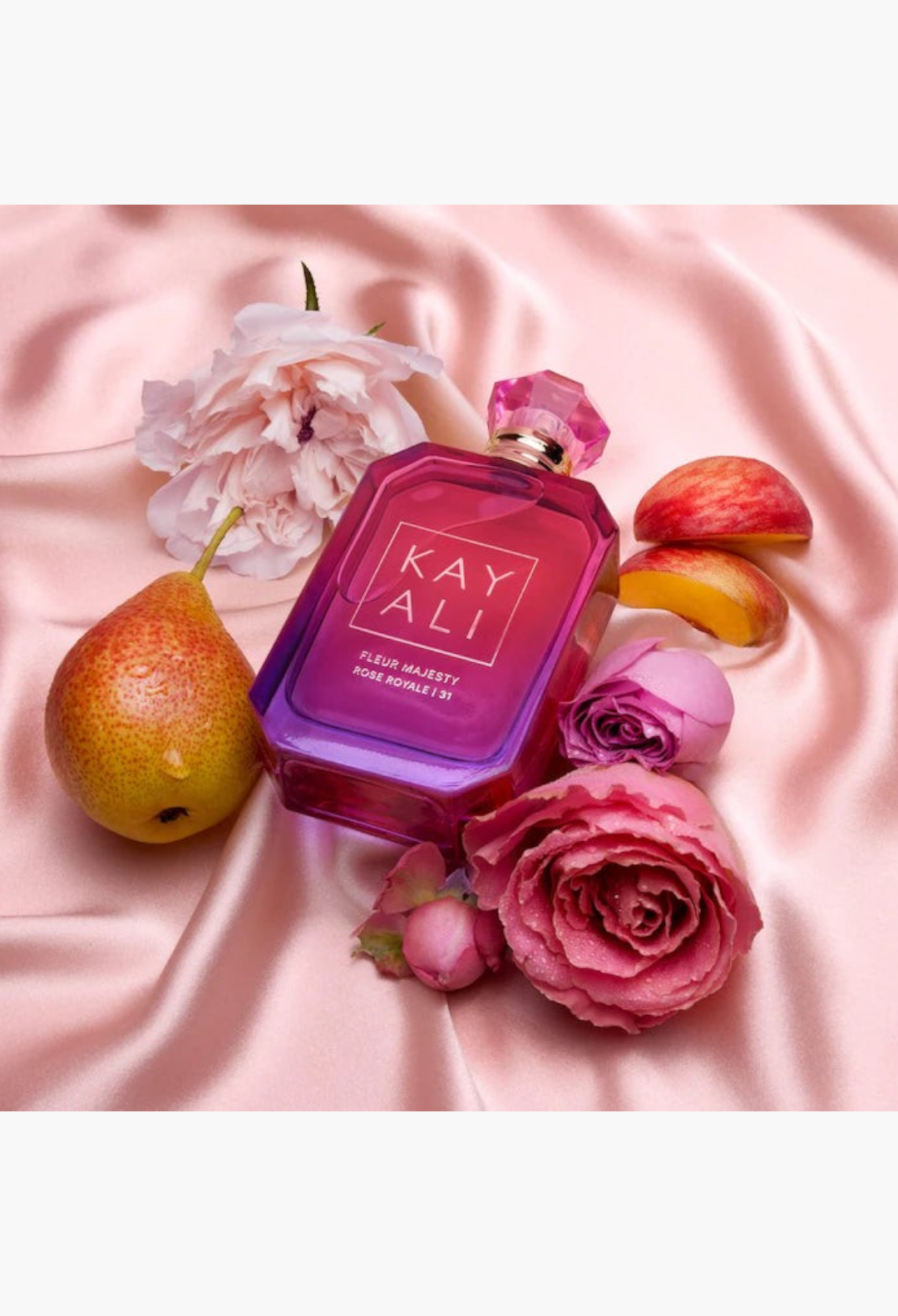 GLAM MODA KAYALI Fleur Majesty Rose Royale perfume bottle surrounded by fresh pink roses and ripe pears