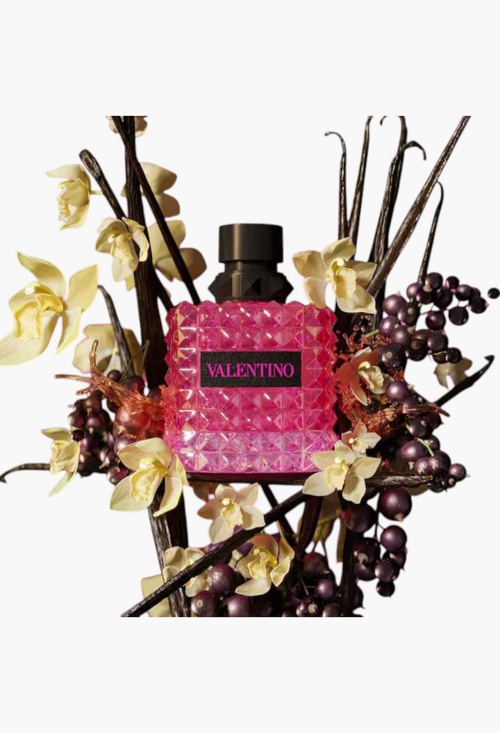 GLAM MODA perfume sampler set featuring a pink Valentino Donna Born in Roma bottle surrounded by floral accents.