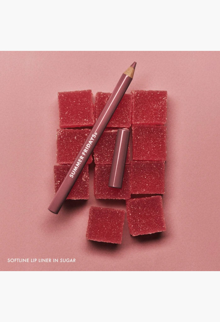 GLAM MODA SoftLine creamy sculpting lip pencil in a deep berry shade displayed with red sugar-coated gummy squares.