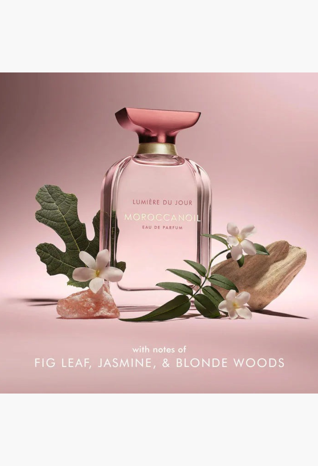 GLAM MODA Moroccanoil Lumiere du Jour perfume bottle in pink glass with floral and stone accents on white background