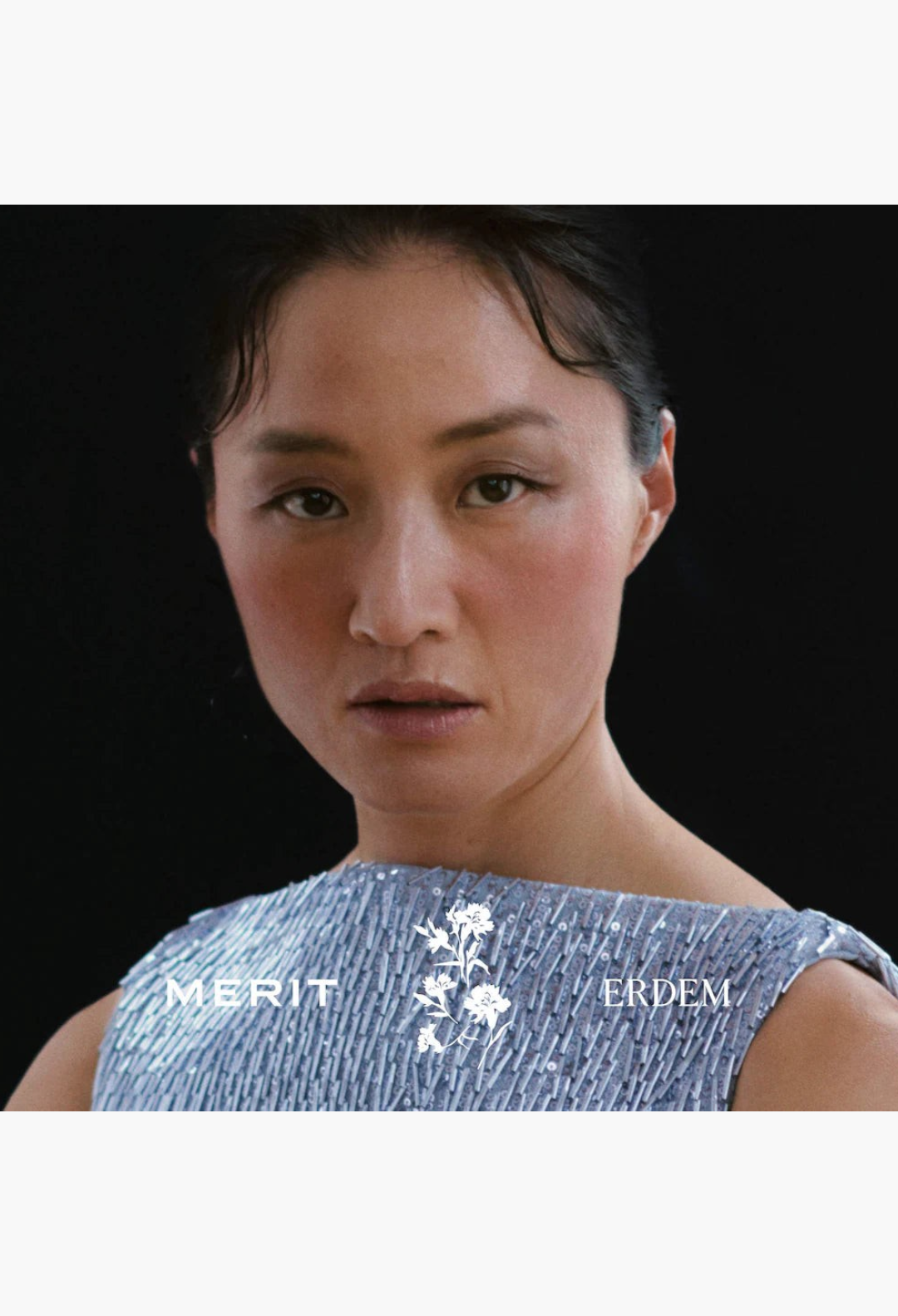 GLAM MODA model wearing a soft, glowy makeup look from the MERIT x Erdem Eye and Cheek Gift Set against a black background