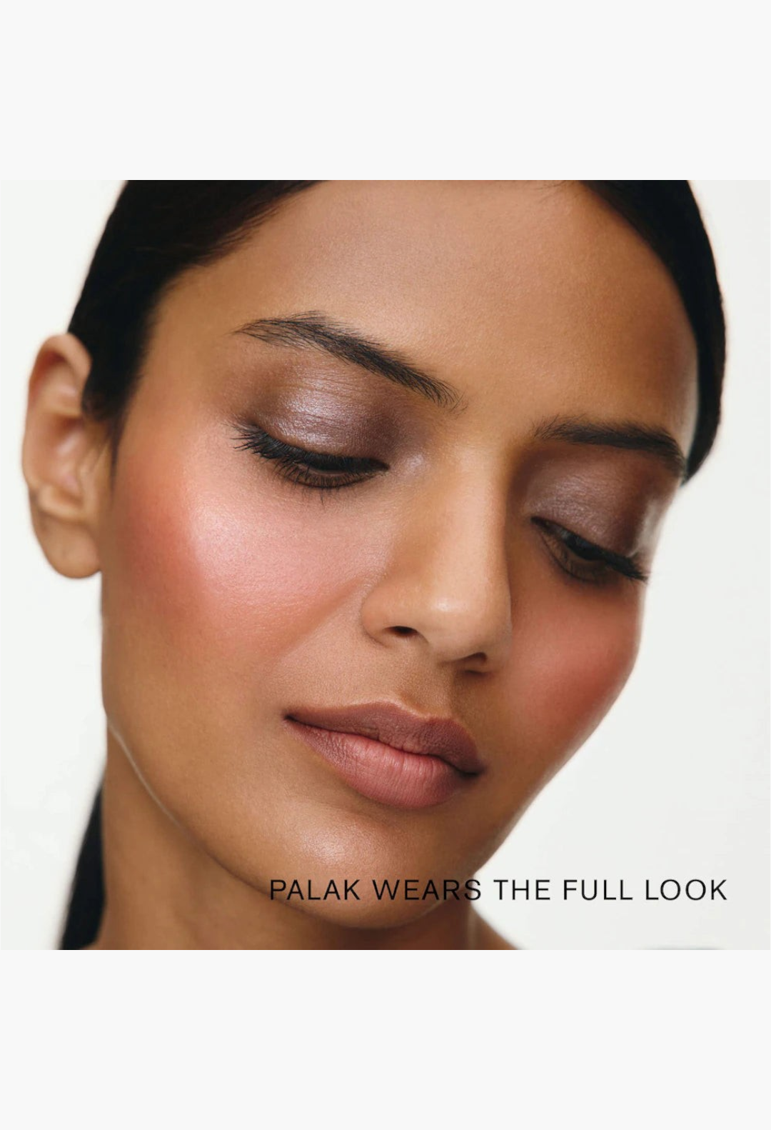 GLAM MODA model wearing a soft, glowy makeup look featuring rose bronze highlighter, pink blush, and shimmer eyeshadow.