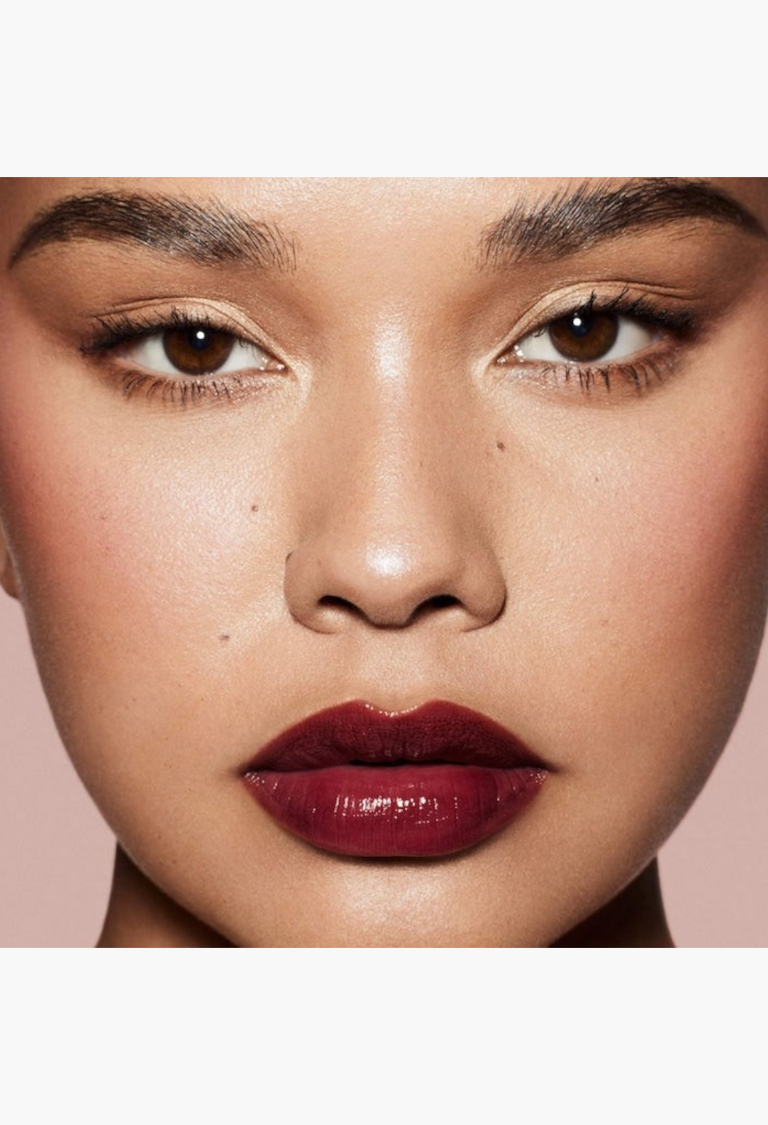 GLAM MODA model wearing a deep berry-brown lip liner and high-shine gloss for a bold, defined pout.